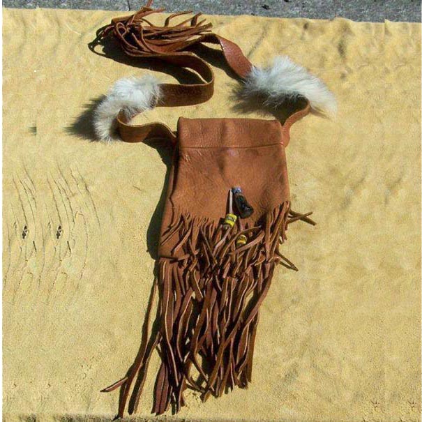Fringed Possibles Bag, made with heavy elkhide decorated with a polished antelope antler tip, old style painted glass beads, tin cones, and coyote fur